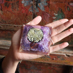 Top view of purple orgone pyramid with sacred tree design