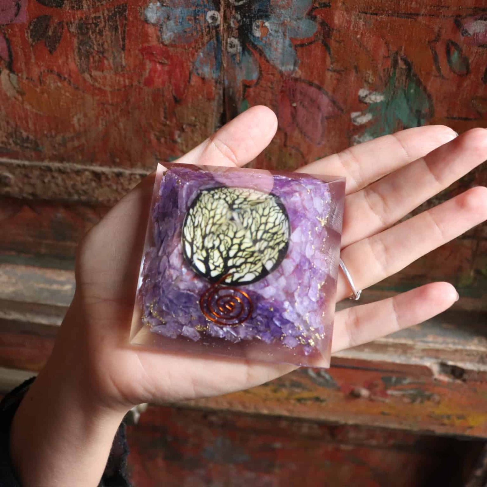Top view of purple orgone pyramid with sacred tree design