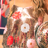 Someone wearing the Sequin Flower Embellished Crop Cami with jeans.