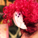 Someone with pink hair wearing the large Ghost Claw hair clip.
