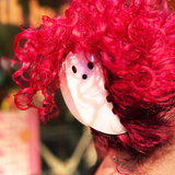 Someone with pink hair wearing the large Ghost Claw hair clip.
