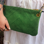 Someone wearing the Chevron Vintage Green Velvet Crossbody Bag with a white skirt.