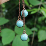 3 crystal amazonite copper necklaces dangling from hand