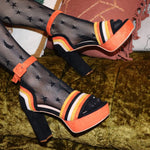 Retro candy corn shoes with vintage peep toe design.