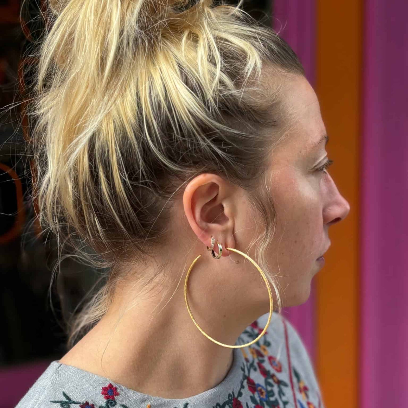 Model wearing 8cm Her Hoops gold earrings by Emma Pills