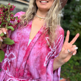 Hand-dyed bohemian kimonos in multiple colors hanging on rack