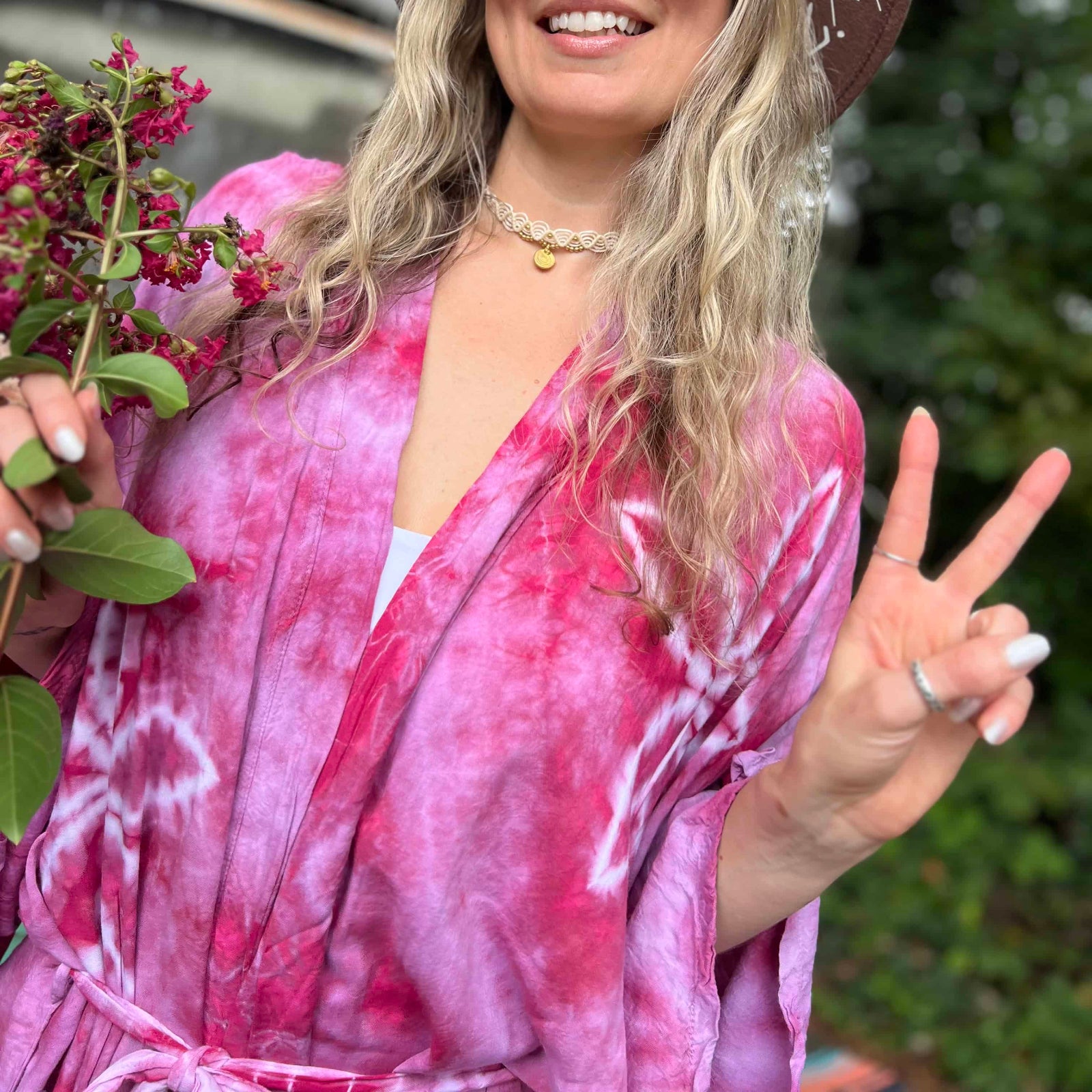 Hand-dyed bohemian kimonos in multiple colors hanging on rack