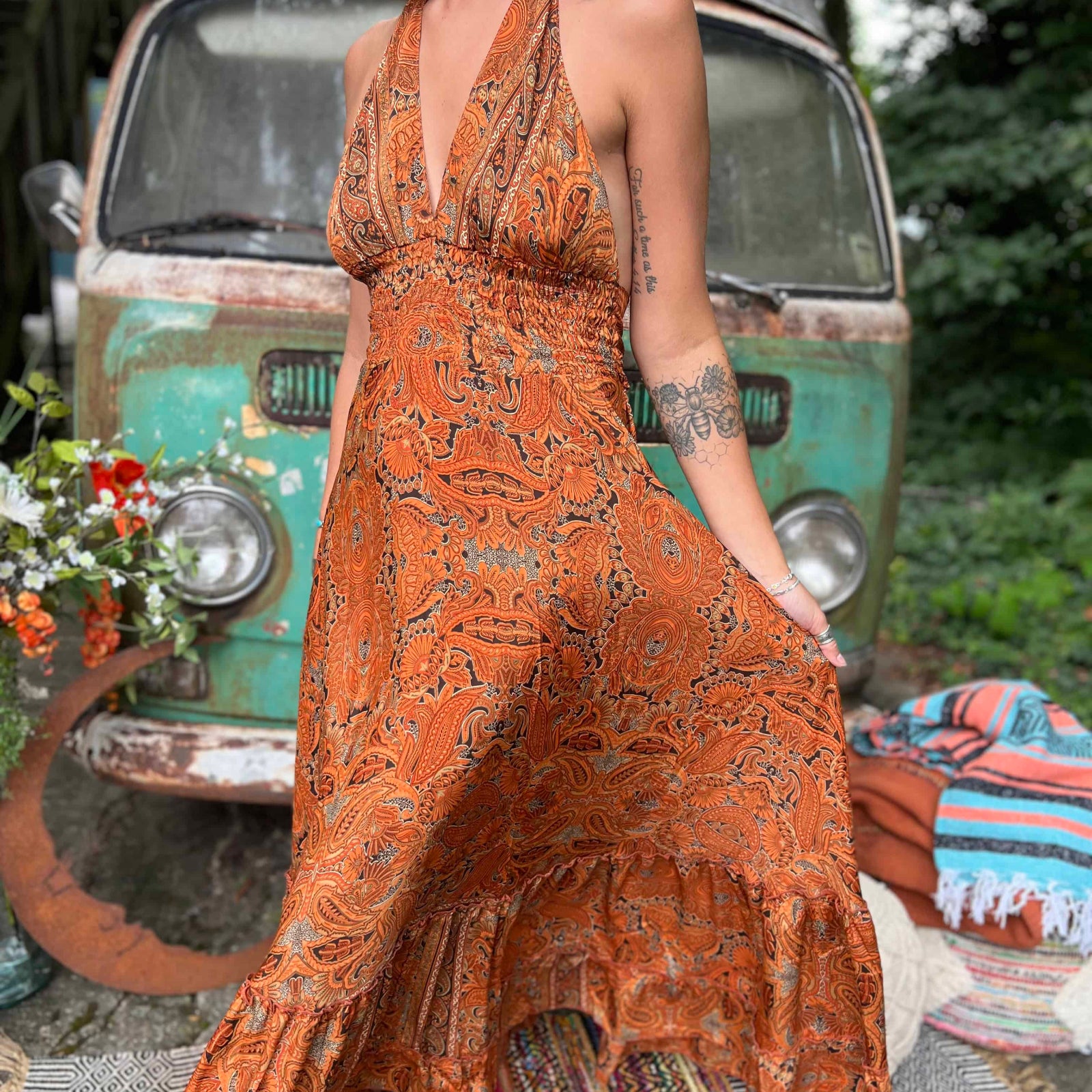Woman twirling in long flowy boho silk maxi dress