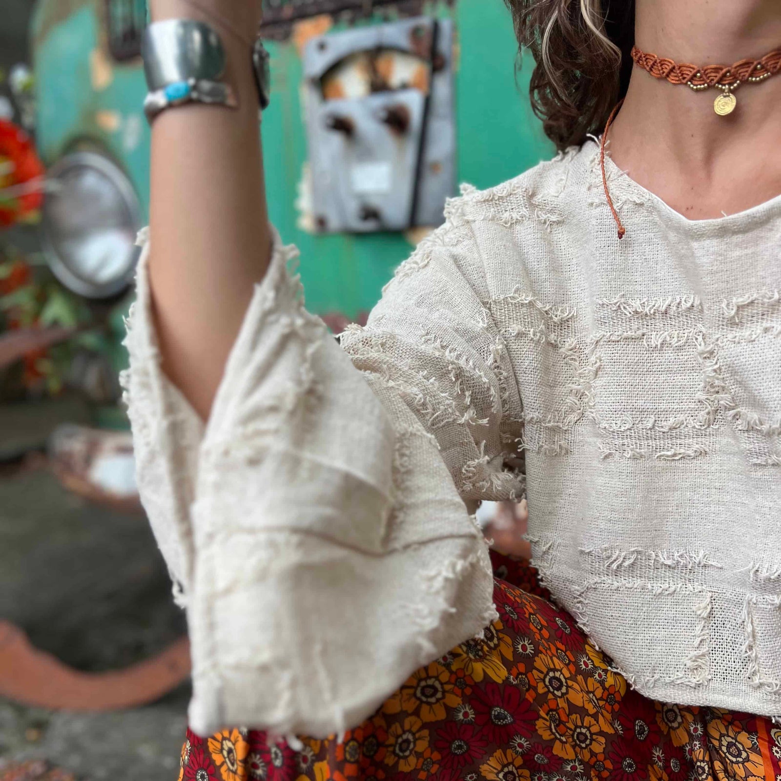 Boho crop top with bell sleeves in natural sunlight