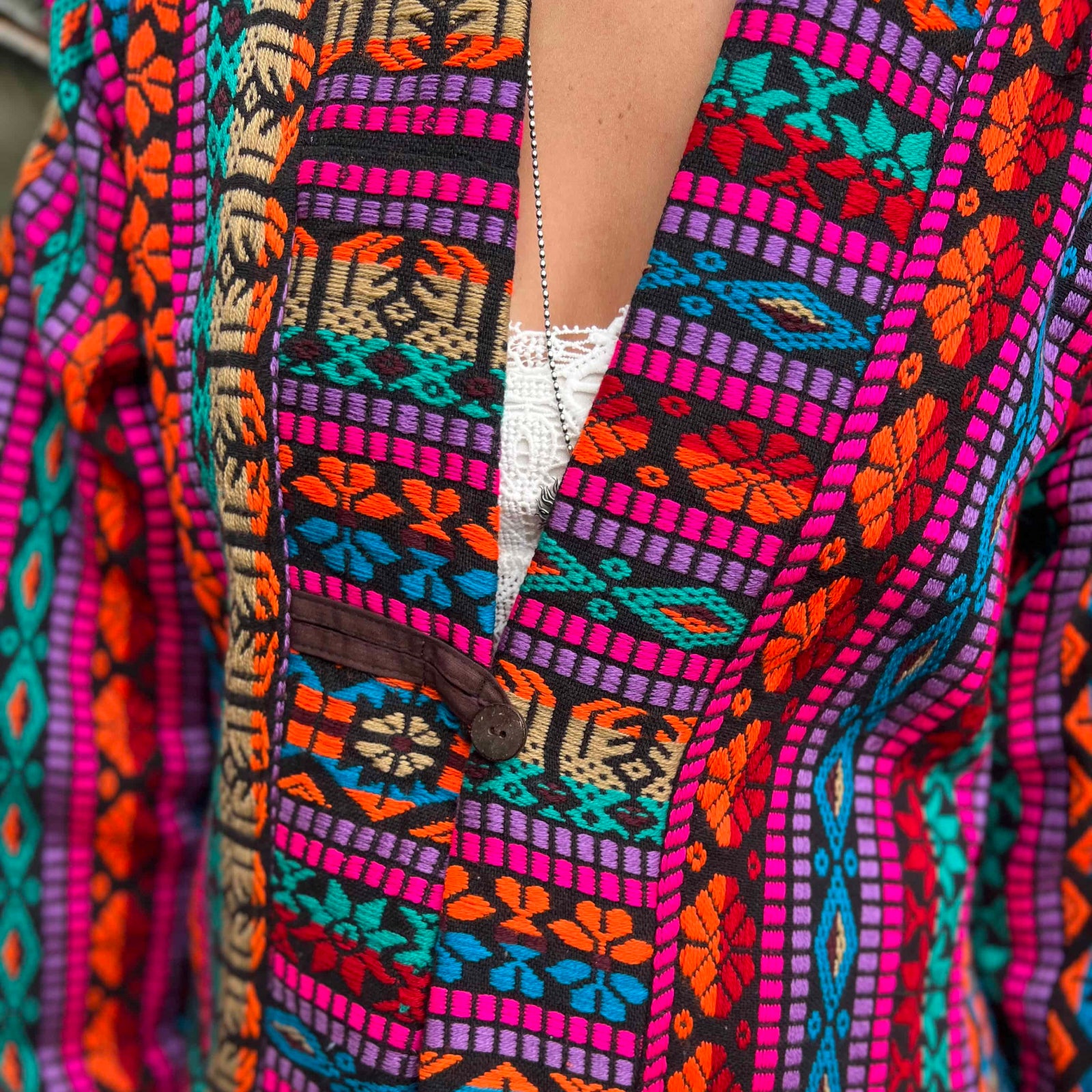 Button closure on handmade hippie boho trench coat