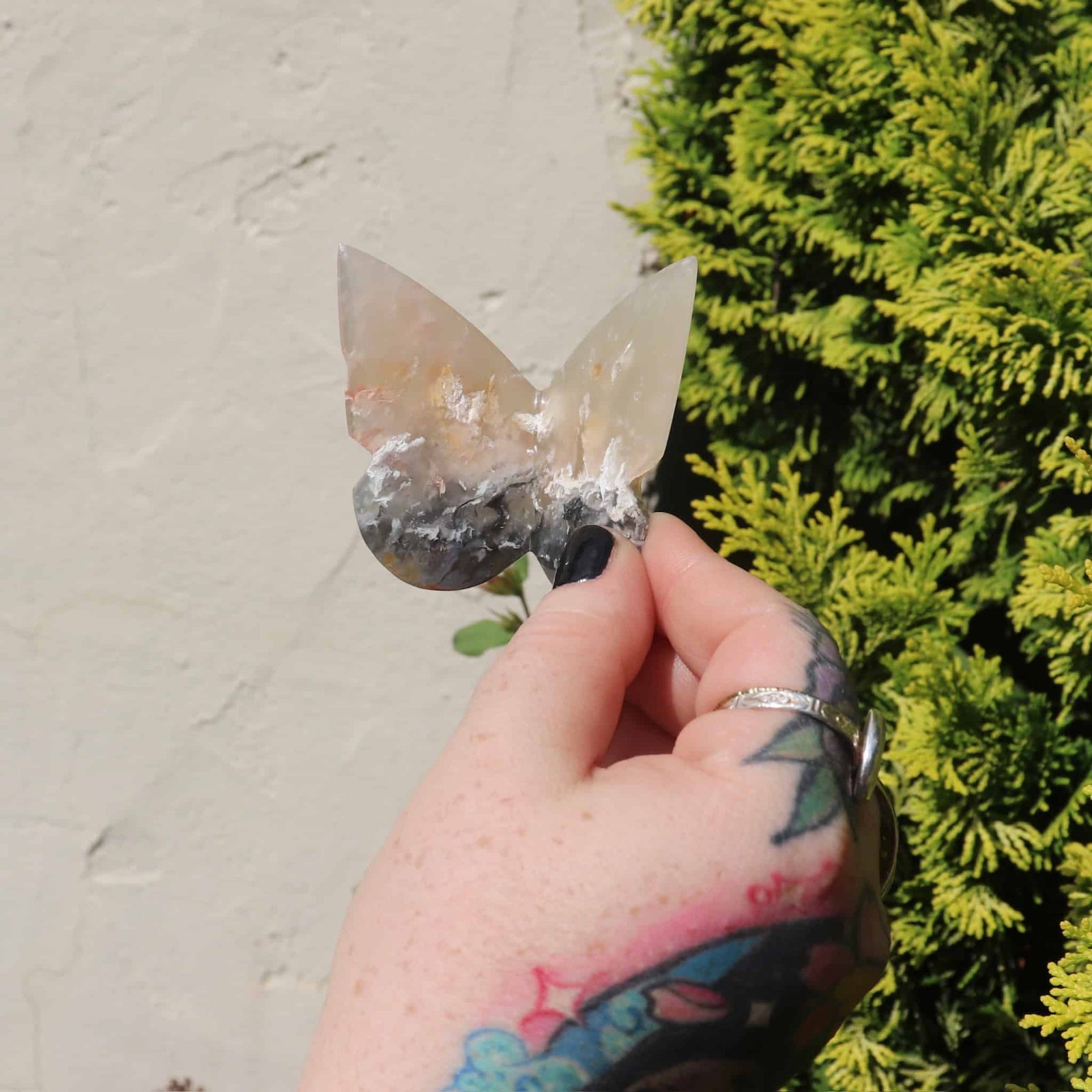 Close-up of pink agate butterfly carving showing unique colors