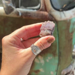 hand holding aragonite crystal sample