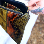 An up close image of the Bronze and Olive Snake Print Pouch