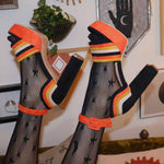 Retro Halloween platform heels in orange and yellow suede.