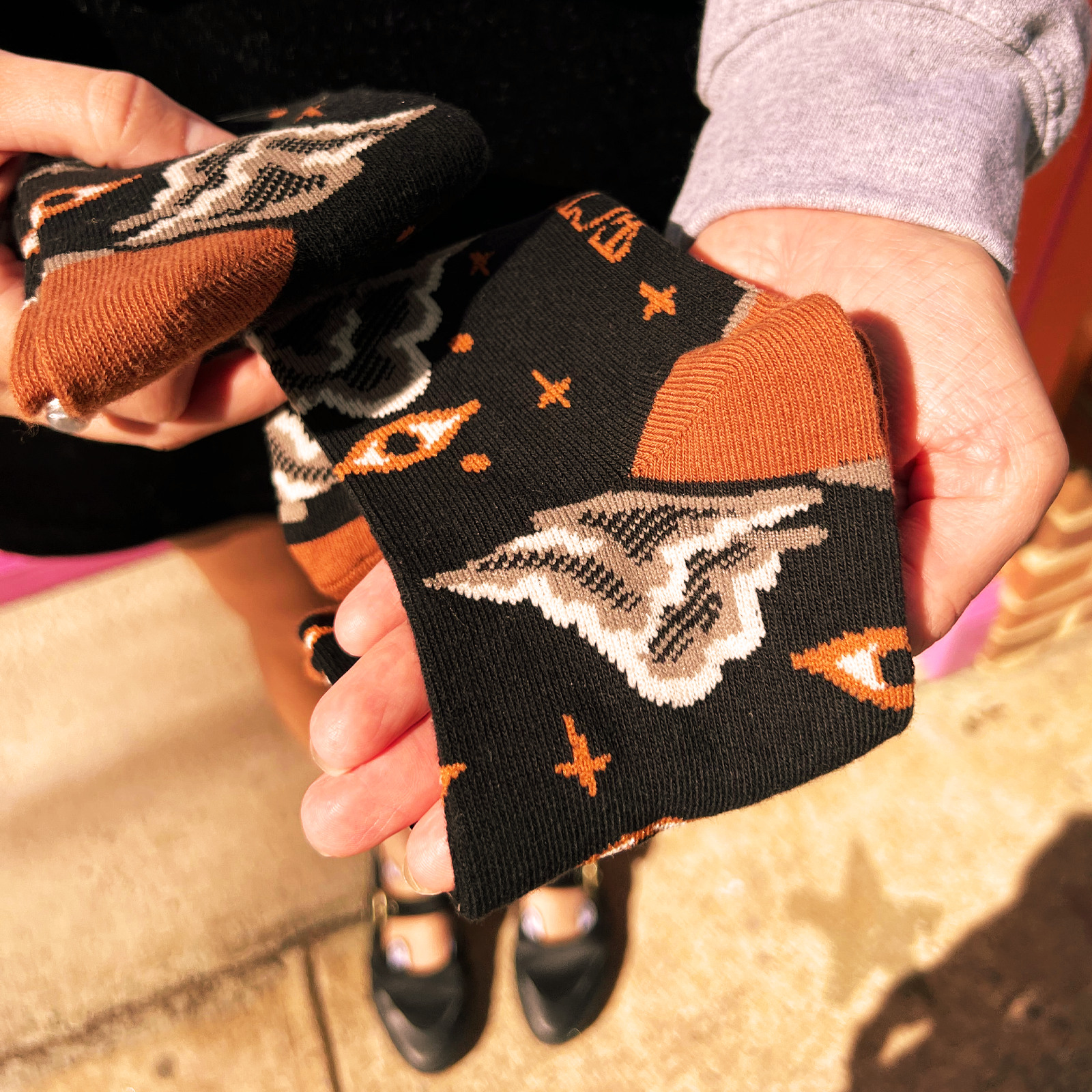 Someone holding a pair of the Starry Eyes Socks.