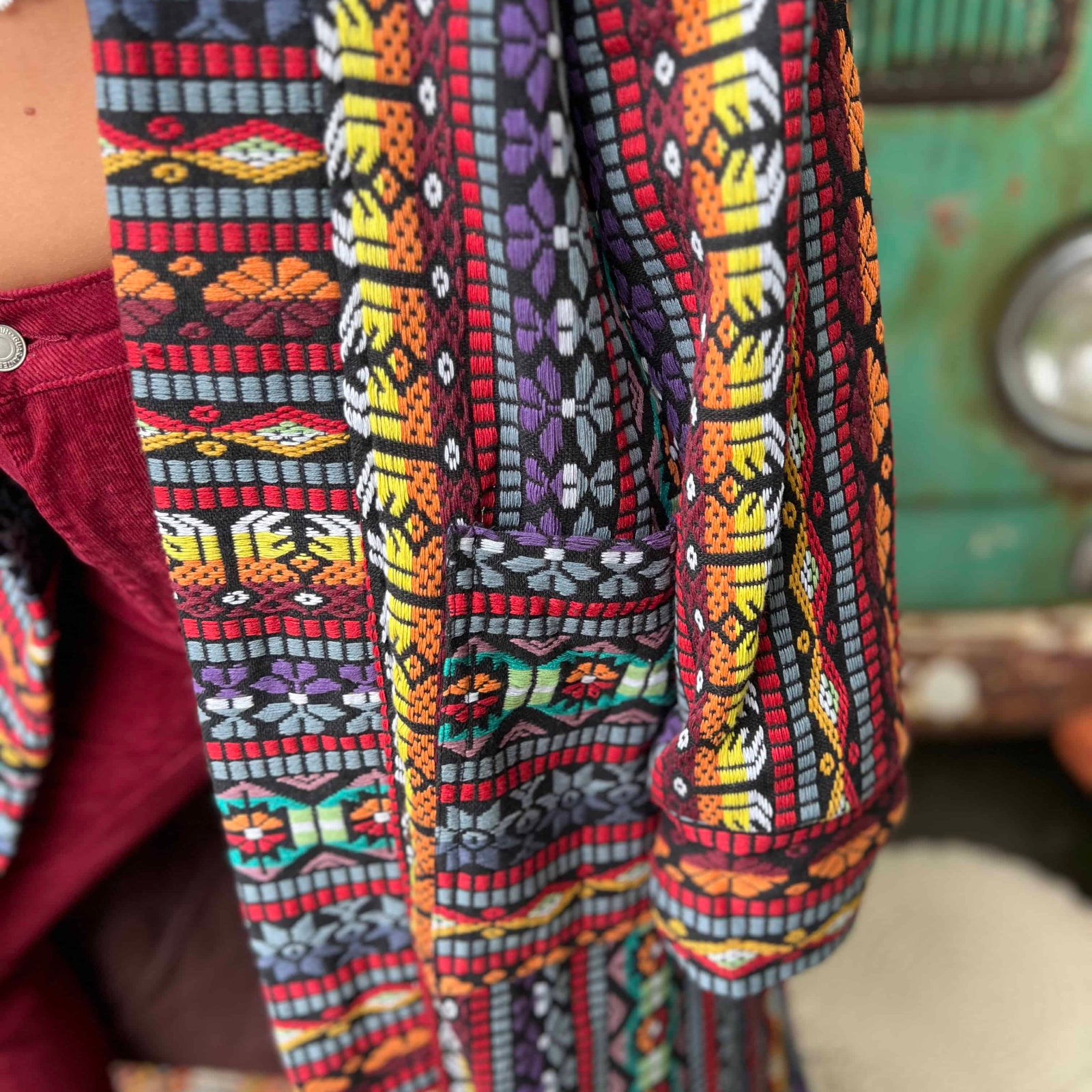 Closeup of buttons on bohemian unisex long trench coat