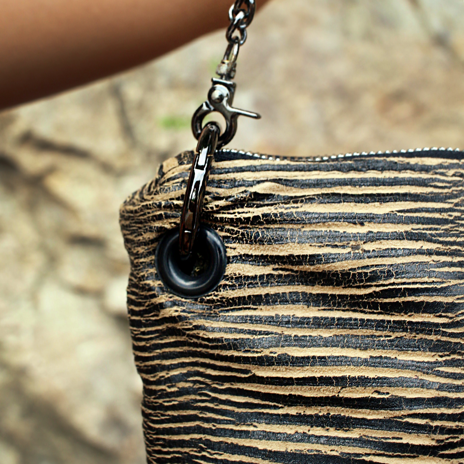 An up close image of the Distressed Black and Tan Bengal Stripe Crossbody Bag.