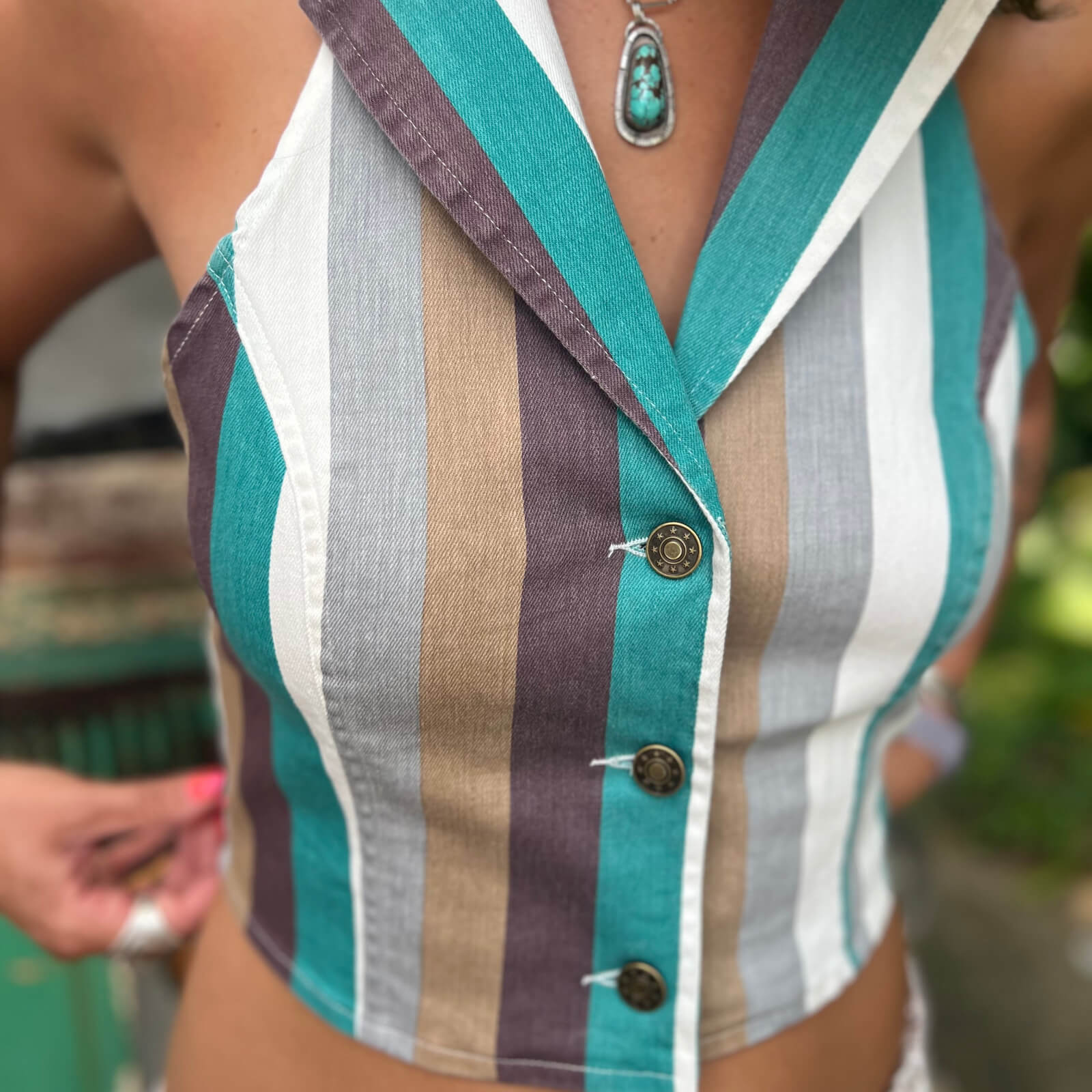 Assorted women’s vests including puffer, sweater, and long vest styles