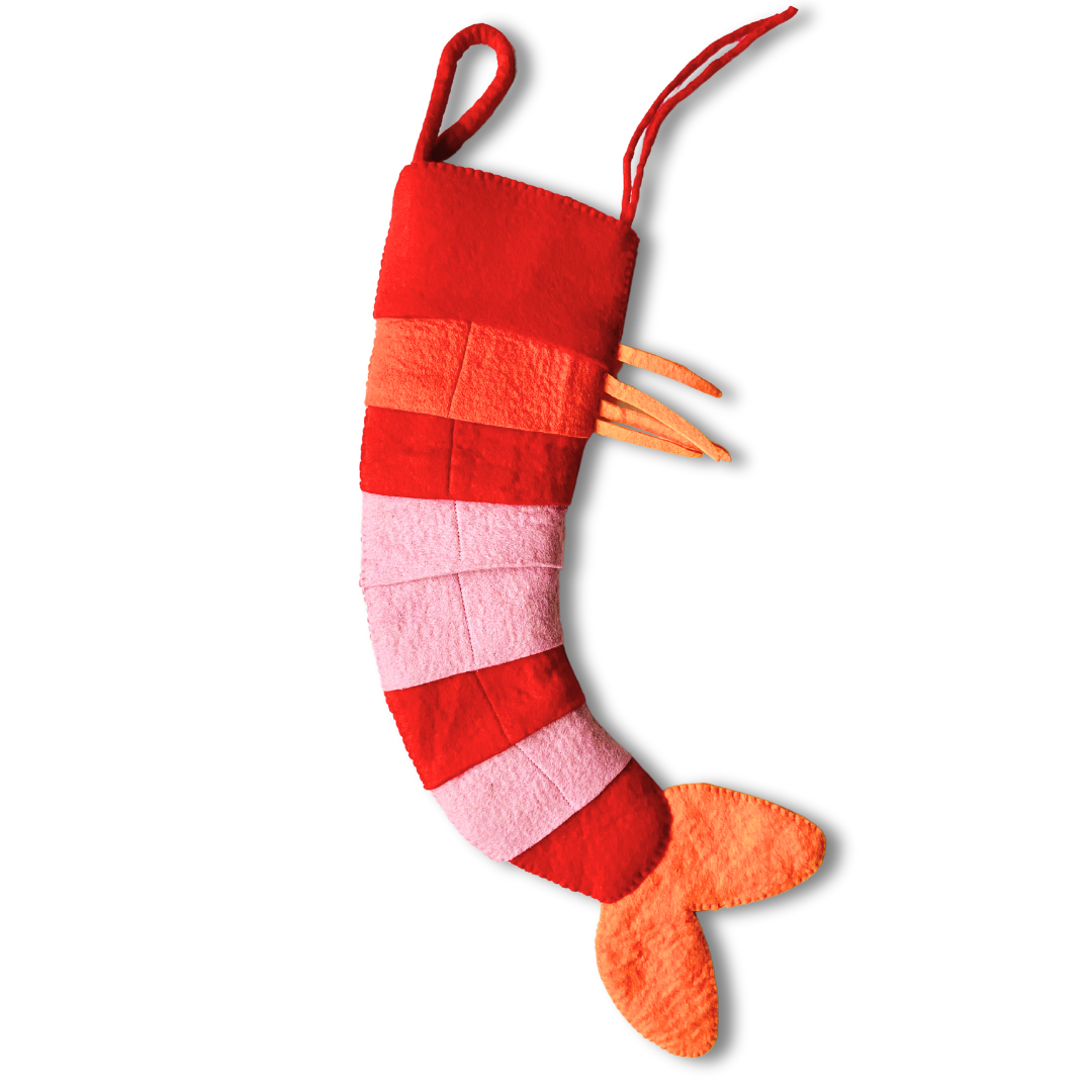 Red, pink, and orange striped christmas stocking resembling a shrimp on a white background