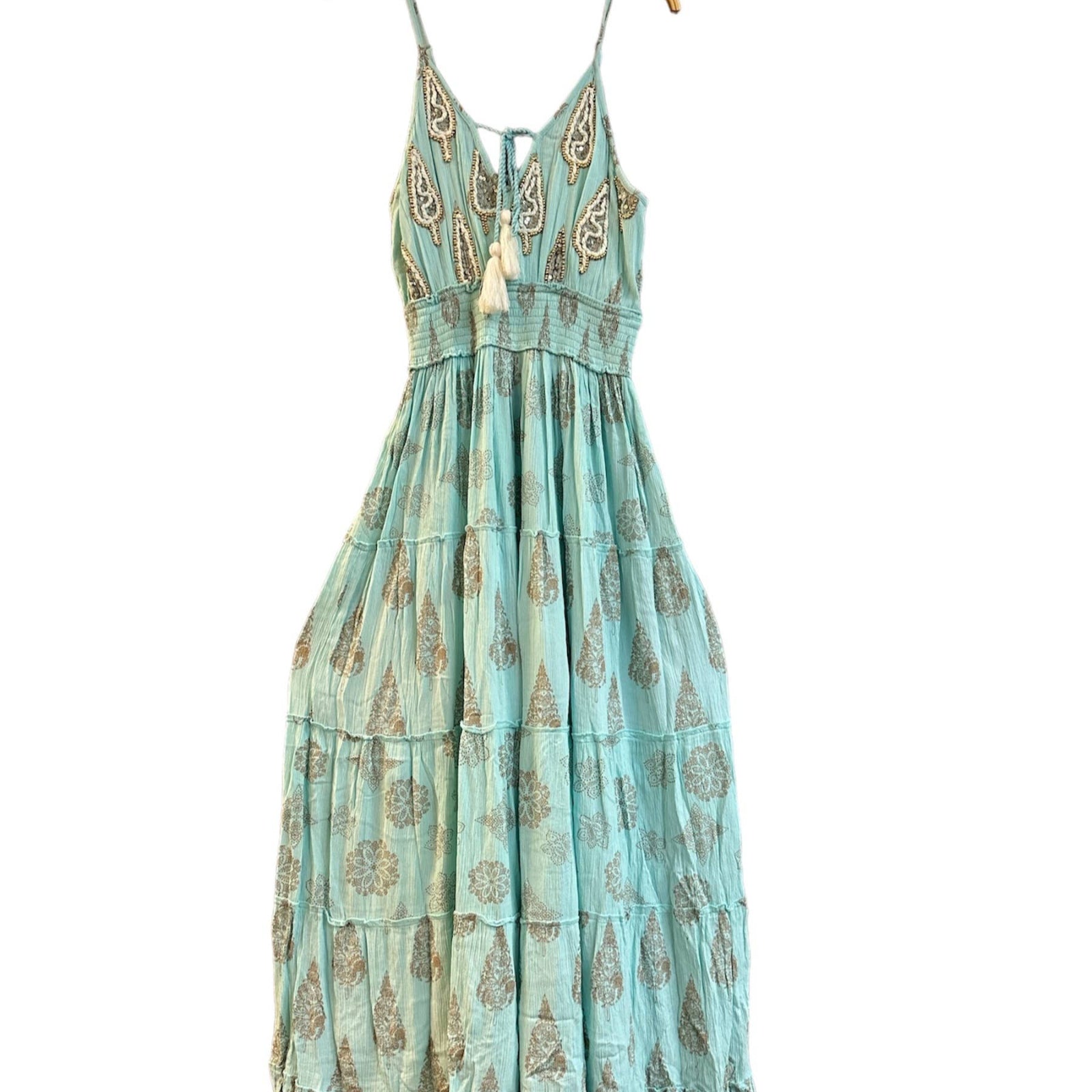 Light blue dress with floral pattern on a hanger against a white background
