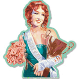 A Chappell Roan sticker depicting a female figure with red hair, wearing a green dress and a sash, holding a trophy and a bouquet of flowers.