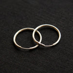 The silver Vintage Endless Hoops Earrings on a black background