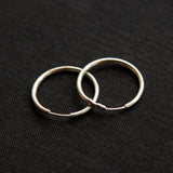 The silver Vintage Endless Hoops Earrings on a black background
