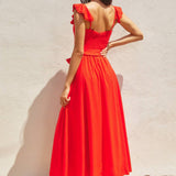 The red heaven corset flutter dress in front of a white background.