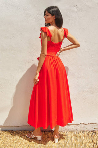 The red heaven corset flutter dress in front of a white background.