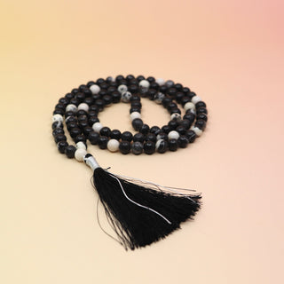Yin Yang Mala Necklace on orange and pink background