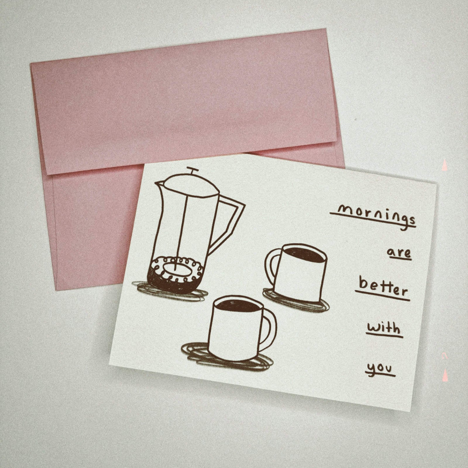 The Coffee Cups - Greeting Card on a gray background.