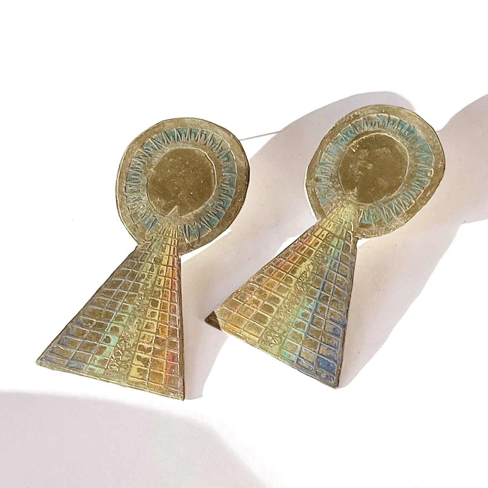 Pair of earrings with geometric design on a white background