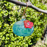 Hummingbird Feeder Blue Glass Hanging on a tree branch