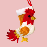 Decorative stocking shaped like a rooster on a pink background