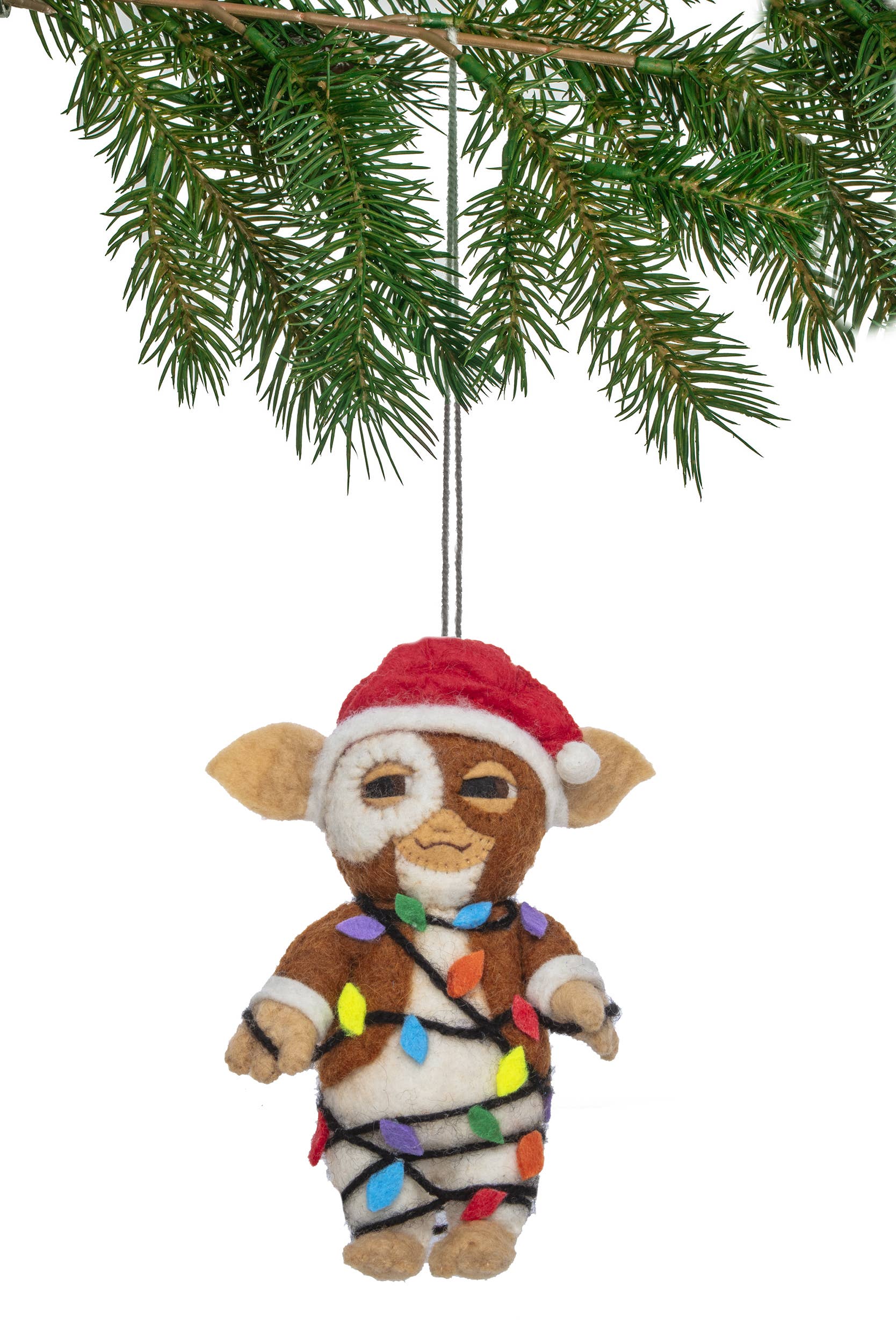 Felt ornament of a character wrapped in Christmas lights hanging from a tree branch.