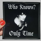 Sticker with a black and white portrait and text 'Who Knows? Only Time' held by a hand.