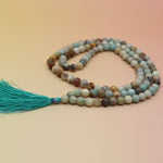 Amazonite 108 Mala Necklace on pink and orange background