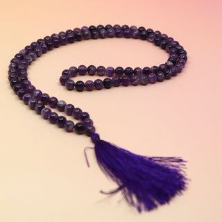 Amethyst 108 Mala Necklace on pink and orange background