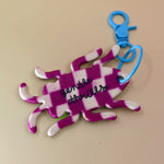 Back of bug keychain showing “Gentle Thrills” logo