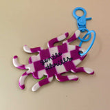 Back of bug keychain showing “Gentle Thrills” logo