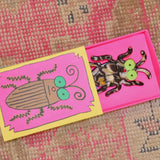 Angled view of boxed keychain with fun artwork and bright colors 