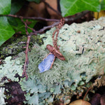 Blue Kyanite mushroom pendant on forest floor with moss and lichen