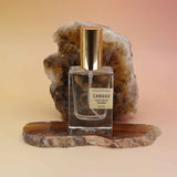 Bohemian Reves Perfume bottle labeled 'Canggu' on a natural stone surface with a warm background
