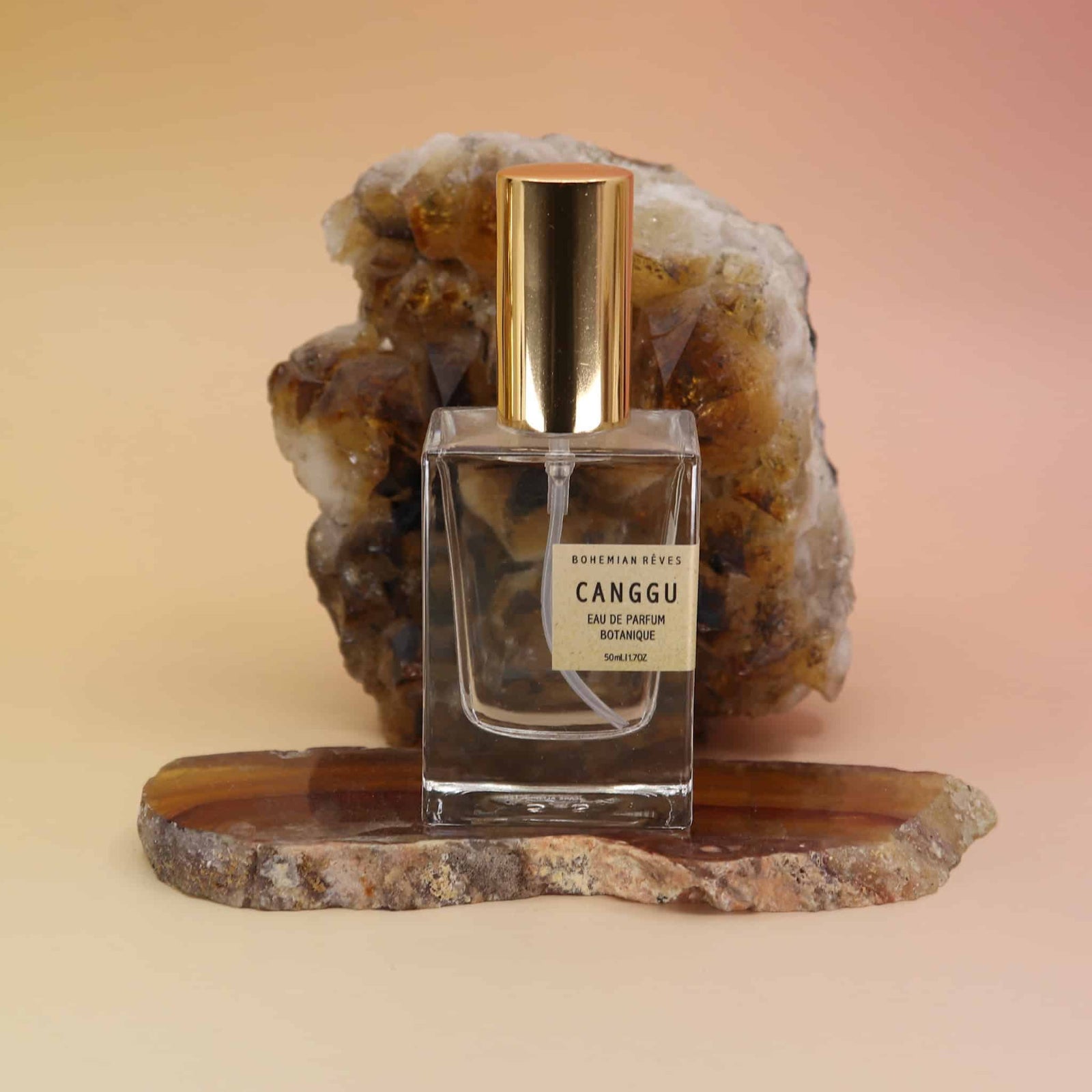 Bohemian Reves Perfume bottle labeled 'Canggu' on a natural stone surface with a warm background