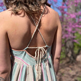 close up view of string tie back on striped sundress 