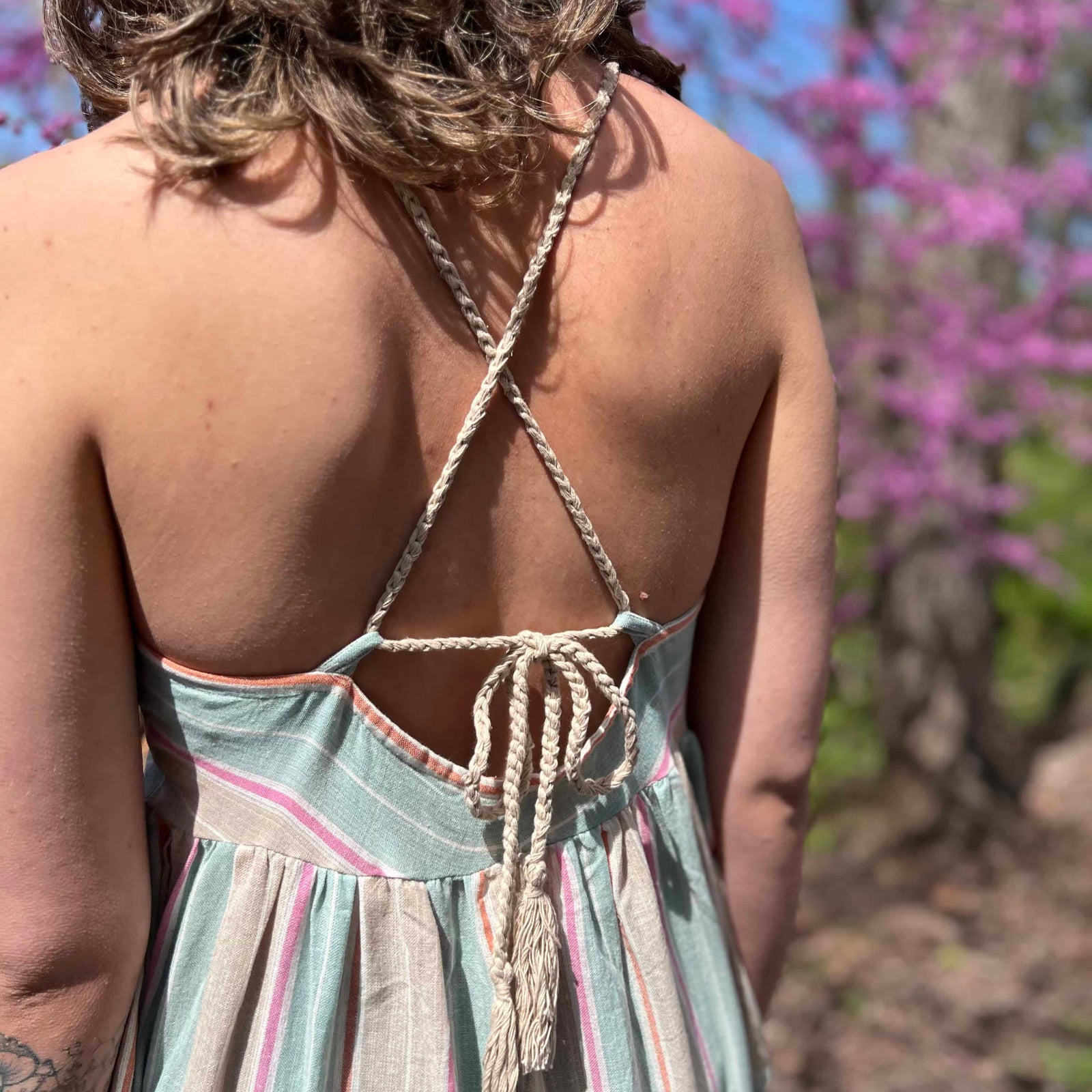 close up view of string tie back on striped sundress 