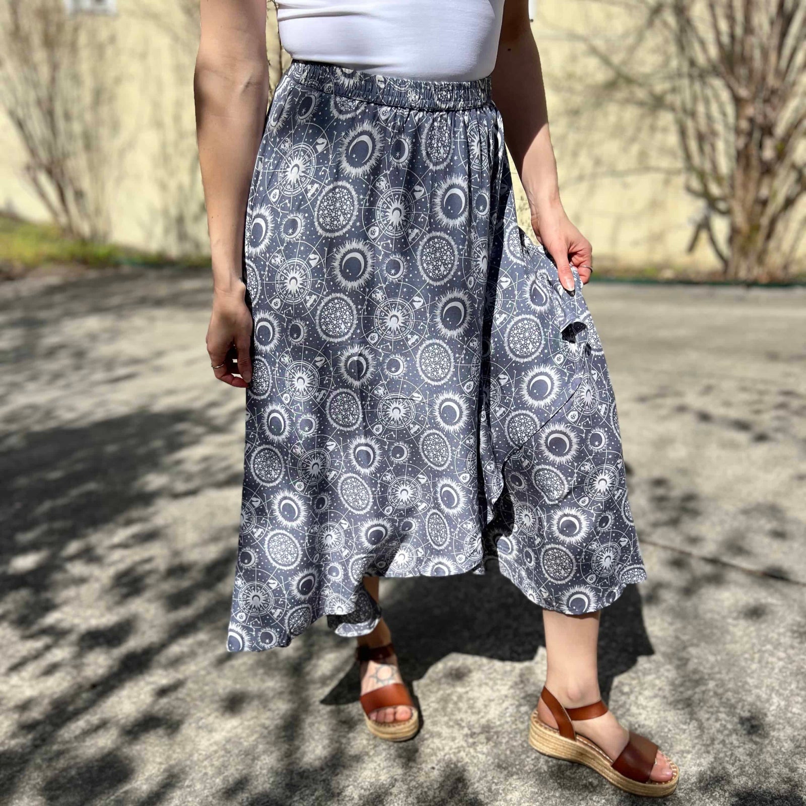 Woman wearing celestial print circle skirt with mandala and moon design
