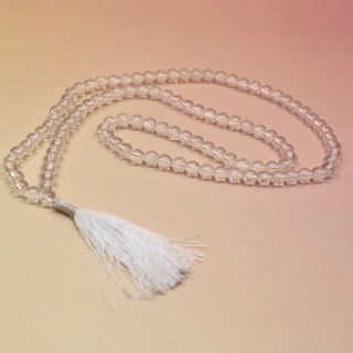 Clear Quartz 108 Mala Necklace on pink and orange background
