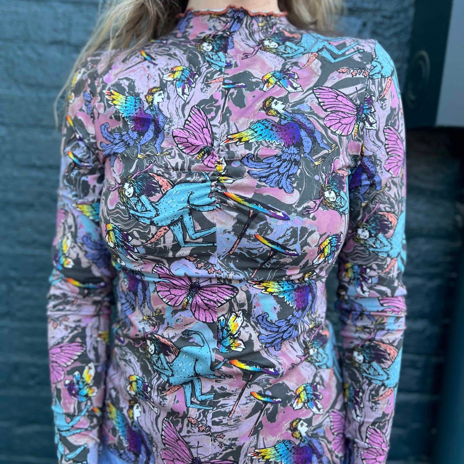 Boho top styled with denim shorts featuring magical fantasy characters and birds