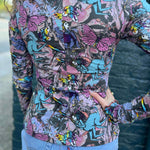 model standing in front of blue wall showing colorful detailed back print
